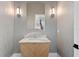 Elegant powder room with marble vanity, patterned wallpaper, and modern lighting at 490 Laguna Dr, Tierra Verde, FL 33715
