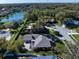 Aerial view of a well-maintained neighborhood, featuring a picturesque lake and lush landscaping at 1105 Deer Run Pl, Valrico, FL 33594