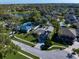 Aerial shot of a neighborhood showcasing well-manicured lawns, mature trees, and a nearby lake at 1105 Deer Run Pl, Valrico, FL 33594