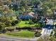 Aerial view of a lush landscape, complemented by beautiful architecture, pool, and charming brick community entrance at 1105 Deer Run Pl, Valrico, FL 33594