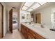 Bathroom with skylights, double sinks, and storage shelves at 1105 Deer Run Pl, Valrico, FL 33594