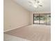 Bright bedroom with plush carpeting, ceiling fan, and sliding glass door leading to outdoor patio at 1105 Deer Run Pl, Valrico, FL 33594