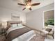 Bedroom featuring neutral walls, a bed with a patterned blanket, and a cushioned chair by a window at 1105 Deer Run Pl, Valrico, FL 33594