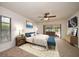 Bedroom includes ceiling fan, a sliding glass door, bench and decorative art at 1105 Deer Run Pl, Valrico, FL 33594
