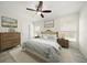 Neutral bedroom with ceiling fan, two windows and calming artwork at 1105 Deer Run Pl, Valrico, FL 33594