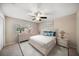 Bright bedroom featuring neutral colors, ceiling fan, white furniture, and a patterned gray rug at 1105 Deer Run Pl, Valrico, FL 33594