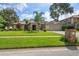 A beautiful single-Gathering home boasts a manicured lawn and a two-car garage on a quiet street at 1105 Deer Run Pl, Valrico, FL 33594