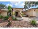 Inviting single-story home with lush tropical landscaping and a cozy seating area at the front entrance at 1105 Deer Run Pl, Valrico, FL 33594