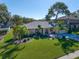 Beautiful home featuring a well-manicured lawn, mature trees, lush landscaping, and a symmetrical design at 1105 Deer Run Pl, Valrico, FL 33594