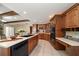 Open kitchen with beautiful wood cabinetry, stainless steel appliances, and tiled flooring at 1105 Deer Run Pl, Valrico, FL 33594