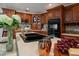 Modern kitchen featuring custom wood cabinets, granite countertops, a breakfast bar, and stainless steel appliances at 1105 Deer Run Pl, Valrico, FL 33594