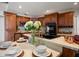Well-equipped kitchen with oak cabinets, granite counters, stainless steel appliances, and gold fixtures at 1105 Deer Run Pl, Valrico, FL 33594