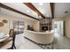 Spacious living room featuring a fireplace, beamed ceilings, and sliding glass doors to the outdoor area at 1105 Deer Run Pl, Valrico, FL 33594