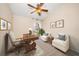 Comfortable office with natural light from a large window, decorative art, and comfortable chairs for receiving clients at 1105 Deer Run Pl, Valrico, FL 33594
