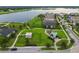 Aerial view of community park with playground, picnic shelter, green space, and a scenic lake, promoting an active lifestyle at 11464 Chilly Water Ct, Riverview, FL 33569