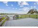 Community dock overlooking a calm lake with green landscaping and a sunny sky at 11464 Chilly Water Ct, Riverview, FL 33569