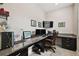 Home office setup with a large desk, comfortable chair, built-in storage, and ample workspace at 11464 Chilly Water Ct, Riverview, FL 33569