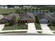 Well-maintained home with lush landscaping, a manicured lawn, and a pristine driveway at 6342 Kenava Loop, Palmetto, FL 34221