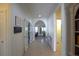 Inviting hallway featuring tile floors, decorative archways, and easy access to multiple rooms at 6342 Kenava Loop, Palmetto, FL 34221