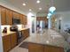 Spacious kitchen featuring a large island with seating, stainless steel appliances, and granite countertops at 6342 Kenava Loop, Palmetto, FL 34221