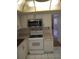Kitchen with white cabinets and appliances at 8100 Dr Martin Luther King Jr N St # 208, St Petersburg, FL 33702