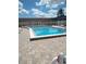 Community pool with surrounding patio and lounge chairs at 8100 Dr Martin Luther King Jr N St # 208, St Petersburg, FL 33702