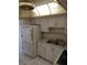 Kitchen with white cabinets and appliances at 8100 Dr Martin Luther King Jr N St # 208, St Petersburg, FL 33702
