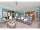 Open living space with gray couches, and adjacent kitchen and dining area at 6342 Kenava Loop, Palmetto, FL 34221