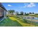 Backyard with pond, fence, and lush landscaping at 6342 Kenava Loop, Palmetto, FL 34221