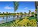 Landscaped backyard with pond view and privacy fence at 6342 Kenava Loop, Palmetto, FL 34221
