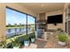 Outdoor kitchen with stainless steel appliances and granite countertops at 6342 Kenava Loop, Palmetto, FL 34221