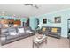Relaxing living room with gray couches and a modern fireplace at 6342 Kenava Loop, Palmetto, FL 34221