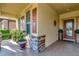 Covered porch with stone columns and potted plants at 6342 Kenava Loop, Palmetto, FL 34221