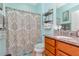 Clean bathroom with a shower/tub combo, granite countertop, and neutral decor at 6342 Kenava Loop, Palmetto, FL 34221