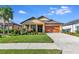One-story house with orange garage door and landscaped yard at 6342 Kenava Loop, Palmetto, FL 34221
