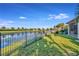 Grass backyard with pond and fence views at 6342 Kenava Loop, Palmetto, FL 34221