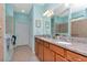Double vanity bathroom with granite countertop and large mirror at 6342 Kenava Loop, Palmetto, FL 34221