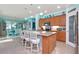 Open kitchen with granite island, stainless steel appliances, and breakfast bar at 6342 Kenava Loop, Palmetto, FL 34221