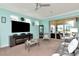 Spacious living room with a fireplace, large TV, and access to a patio at 6342 Kenava Loop, Palmetto, FL 34221