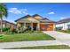 One-story house with orange garage door and landscaped yard at 6342 Kenava Loop, Palmetto, FL 34221