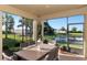 Relaxing screened patio with table and chairs, overlooking a pond at 6342 Kenava Loop, Palmetto, FL 34221