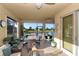 Enclosed patio with seating and dining areas, overlooking tranquil water views at 6342 Kenava Loop, Palmetto, FL 34221