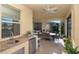Outdoor bar with granite countertop, sink, and mini-fridge at 6342 Kenava Loop, Palmetto, FL 34221