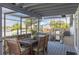 Screened deck with outdoor dining area and grill at 2202 Donato Dr, Belleair Beach, FL 33786