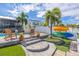 Relaxing pool and patio with steps leading to the backyard at 2202 Donato Dr, Belleair Beach, FL 33786