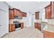 Modern kitchen with granite counters and dark wood cabinets at 7806 Grasmere Dr, Land O Lakes, FL 34637