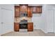 Modern kitchen with stainless steel appliances and dark wood cabinets at 7806 Grasmere Dr, Land O Lakes, FL 34637