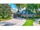 Community clubhouse entrance with landscaping and brick walkway at 7806 Grasmere Dr, Land O Lakes, FL 34637