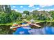 Aerial view of community dock with kayaks and gazebo at 7806 Grasmere Dr, Land O Lakes, FL 34637