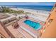 Community pool with oceanfront views and lounge chairs at 18610 Gulf Blvd # 402, Indian Shores, FL 33785